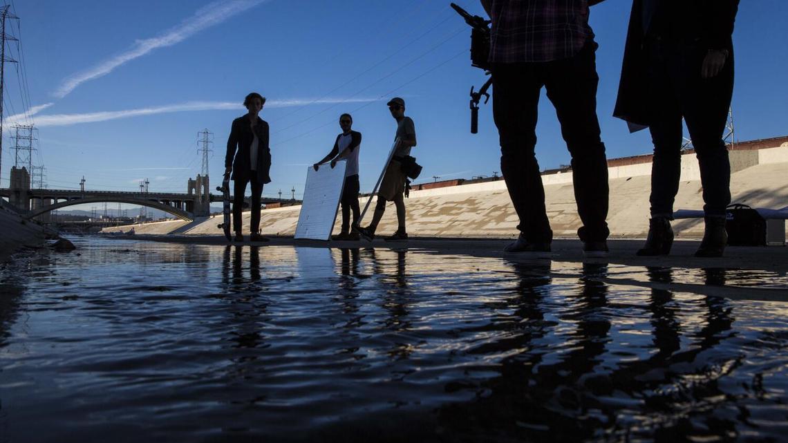 LOS ANGELES, CA - JULY 21: A film crew shoots a fashion commercial along the Los Angeles River on the edge of the Arts District where many film crews and photographers come to use the urban scenery as their backgrounds on Tuesday July 21, 2014. (Jabin Botsford / Los Angeles Times)