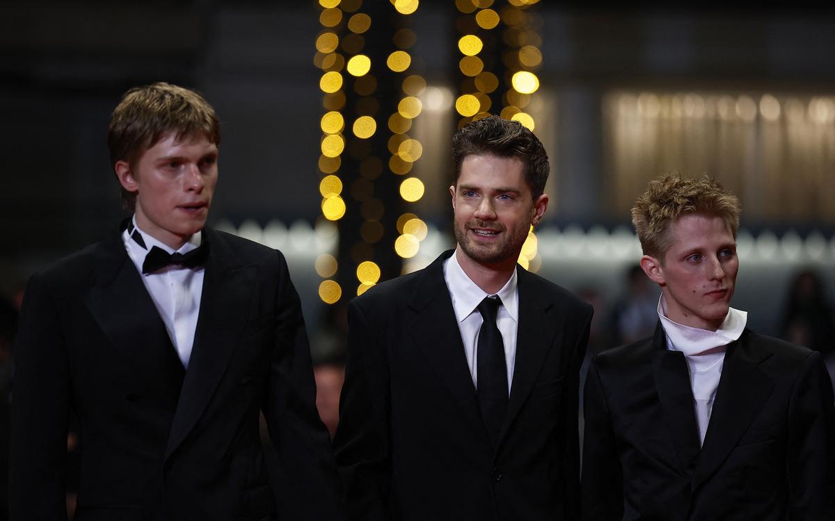 Director Lukas Dhont, cast members Emmanuel Macchia and Valentin Champagne pose on the red carpet during arrivals for the screening of the film "Coward" in competition at the 79th Cannes Film Festival in Cannes, France, May 21, 2026. REUTERS/Sarah Meyssonnier