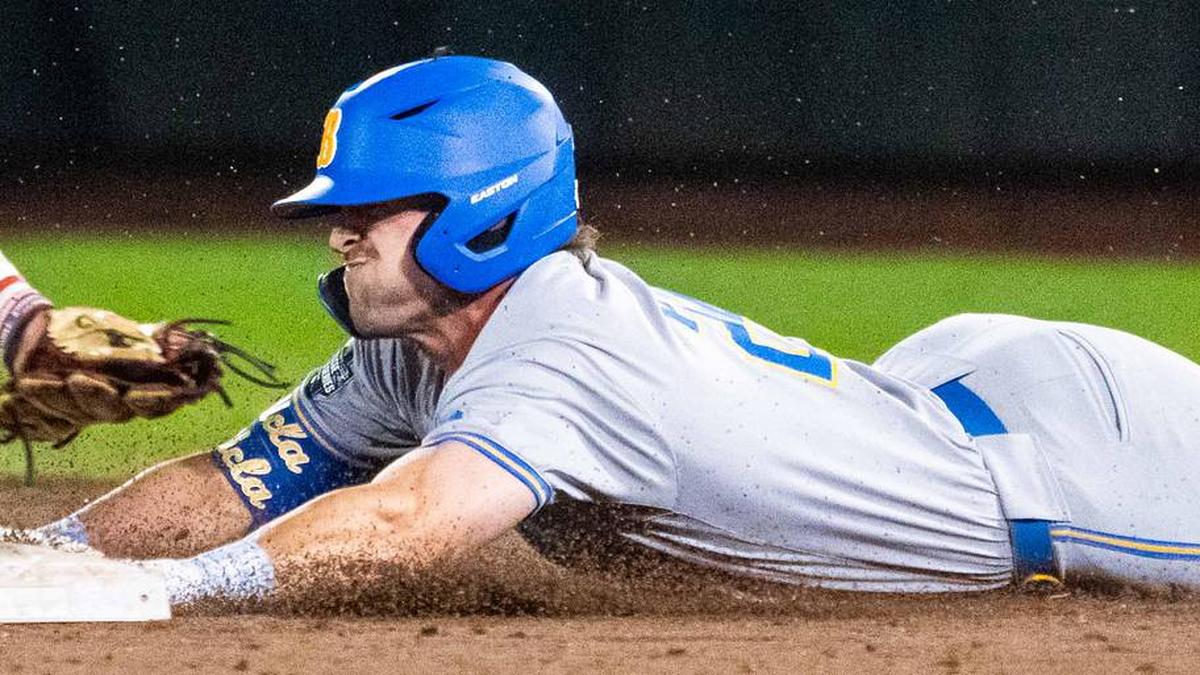  Jun 17, 2025; Omaha, Neb, USA; UCLA Bruins right fielder A.J. Salgado (24) slides to second after hitting an RBI double in the 9th at Charles Schwab Field. Mandatory Credit: Dylan Widger-Imagn Images | Dylan Widger-Imagn Images 