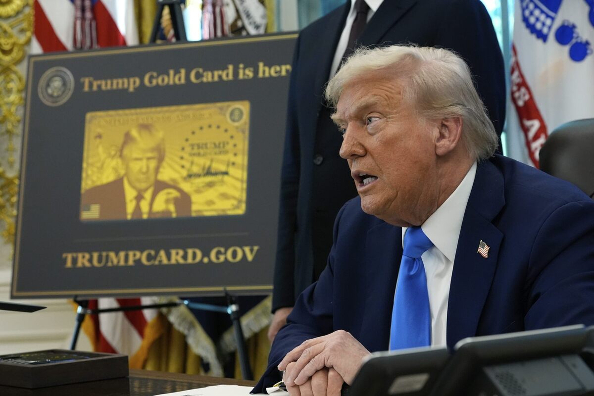  President Donald Trump signs executive orders in the Oval Office next to a poster displaying the Trump Gold Card on Sept. 19, 2025. AP Photo/Alex Brandon 