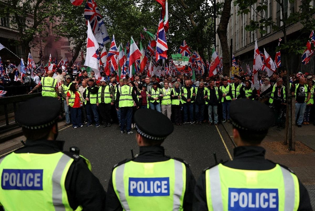 Police officers stand guard as protesters gather on the day of a "Unite the Kingdom" rally organised by British anti-immigration activist Stephen Yaxley-Lennon, also known as Tommy Robinson, in London, Britain, May 16, 2026. REUTERS/Hannah McKay