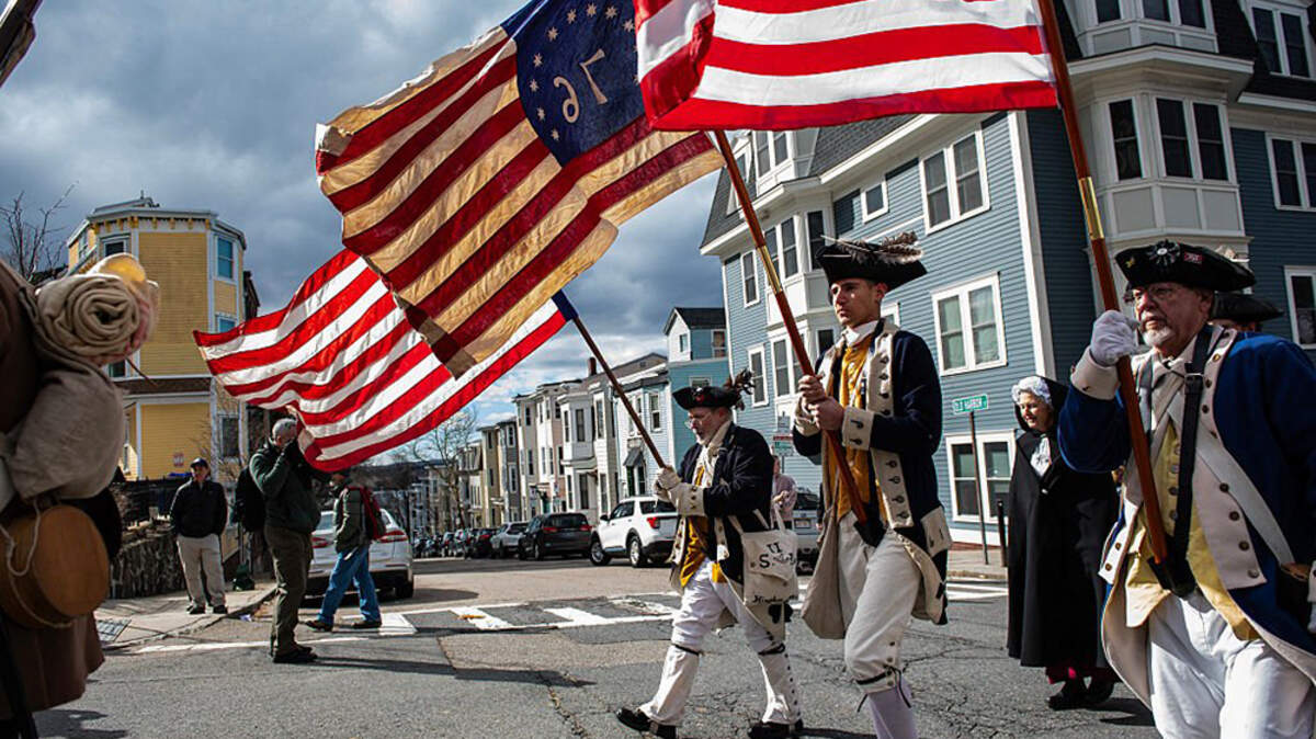 Revolutionary War reenactors march in the Evacuation Day 250 parade in Boston on March 17. The date marks the 250th anniversary of British forces evacuating the city after the siege of Boston in 1776. Among the thousands of events planned in the 13 original colonies to commemorate the adoption of the Declaration of Independence, most are avoiding partisan politics, focusing on diversity and acknowledging past struggles for equal rights.