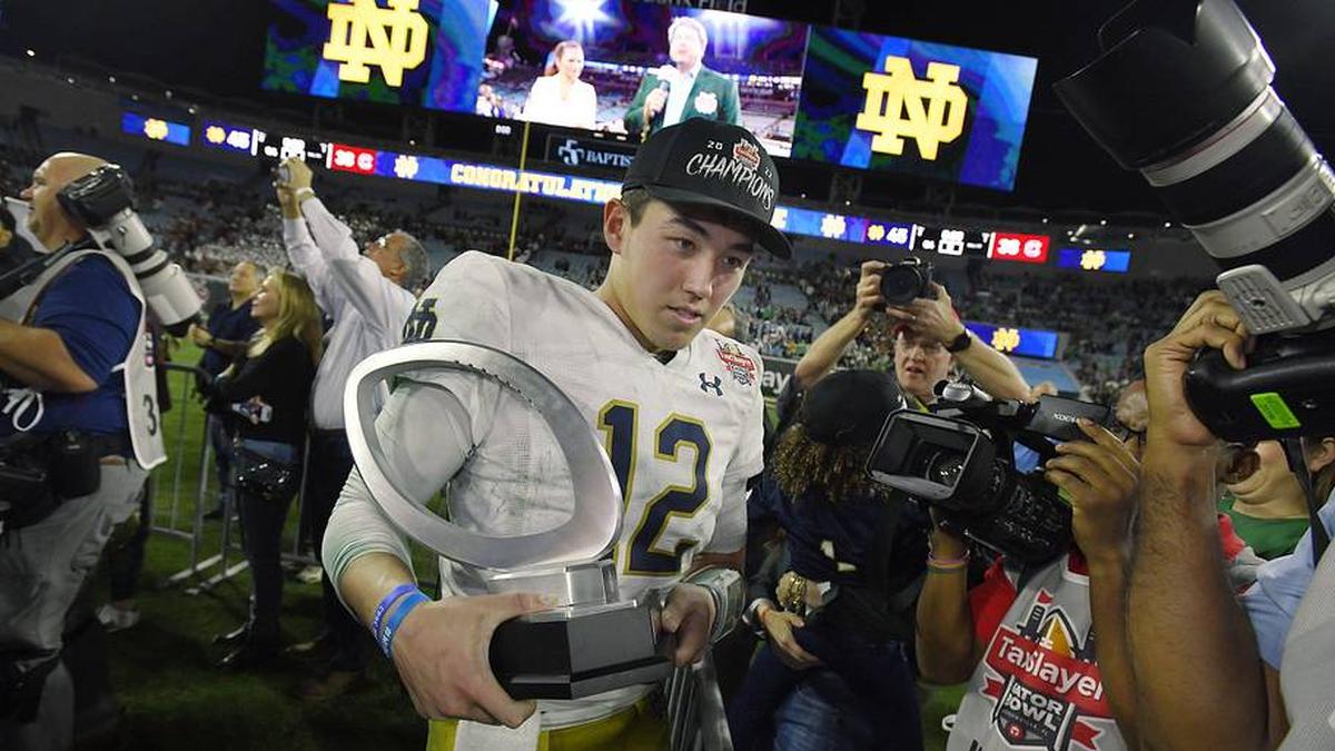  Notre Dame Fighting Irish quarterback Tyler Buchner (12) walks away from the awards ceremony with his MVP game trophy after Friday might's victory over the South Carolina Gamecocks. The University of Notre Dame Fighting Irish took on the University of South Carolina Gamecocks in the TaxSlayer Gator Bowl game in Jacksonville, Florida's TIAA Bank Field Friday, December 30, 2022. The first half ended with South Carolina holding a 24 to 17 lead but Notre Dame came back and with a late fourth quarter | Bob Self/Florida Times-Union / USA TODAY NETWORK 