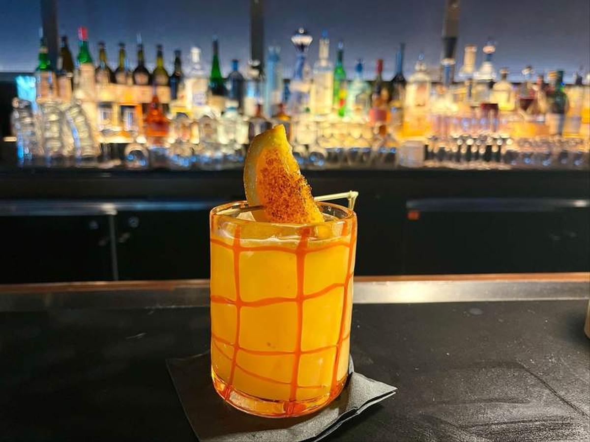  The Burnt Orange cocktail at Todd English's Bluezoo features Herradura Silver tequila infused with brûléed oranges combined with agave, Grand Marnier and orange juice, then topped with a flaming orange. Photo credit: Linnea Bailey 