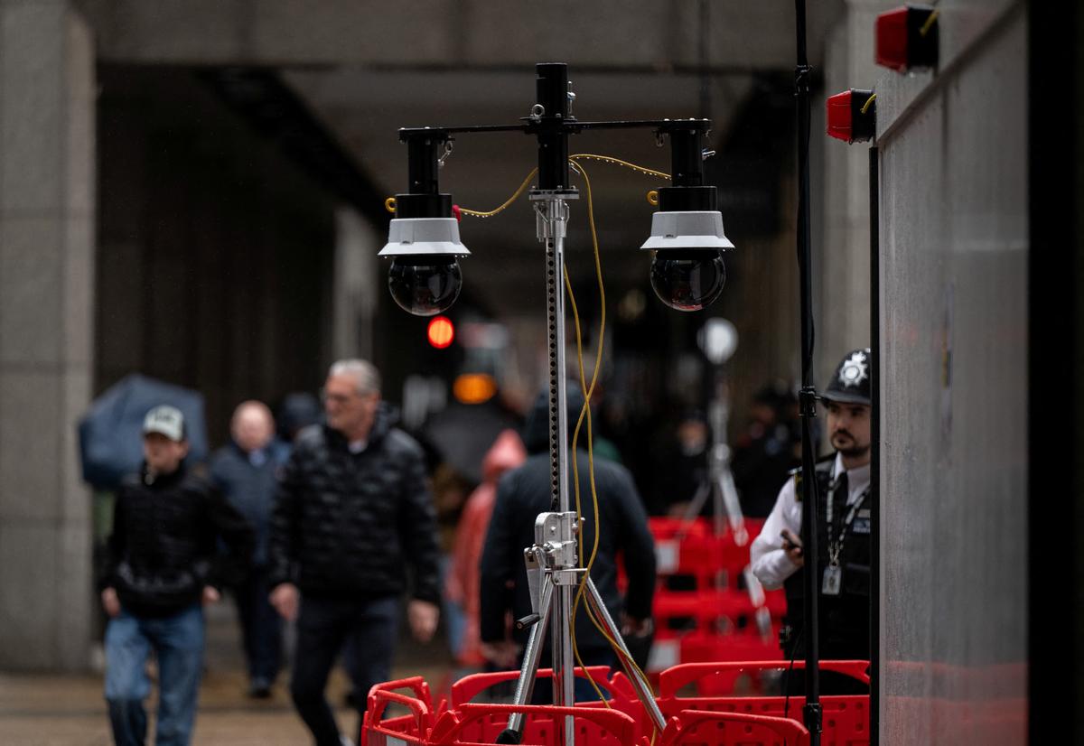 Police officers wait next to cameras as part of a Metropolitan Police live facial recognition operation in London, Britain, May 11, 2026. REUTERS/Chris J. Ratcliffe