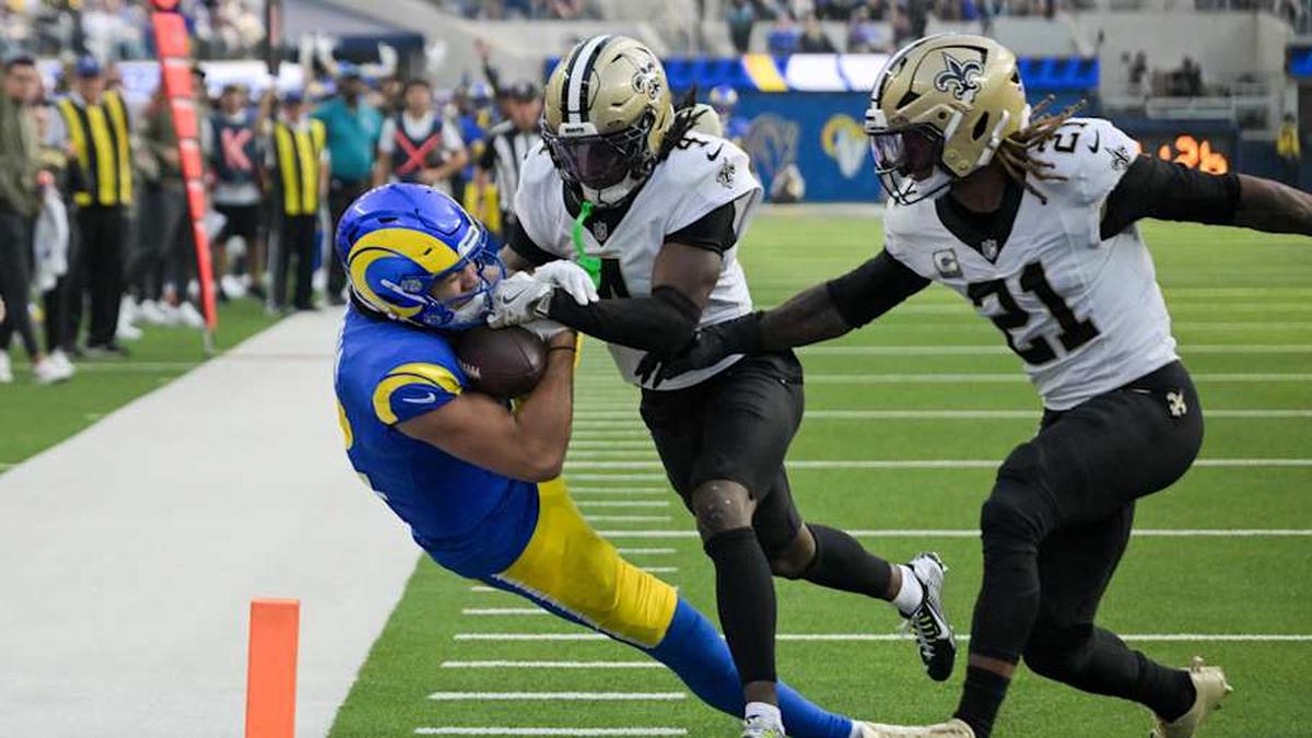  Nov 2, 2025; Inglewood, California, USA; Los Angeles Rams wide receiver Puka Nacua (12) scores a touchdown as New Orleans Saints cornerback Kool-Aid McKinstry (4) and safety Justin Reid (21) defend during the first half at SoFi Stadium. Mandatory Credit: Jayne Kamin-Oncea-Imagn Images | Jayne Kamin-Oncea-Imagn Images 