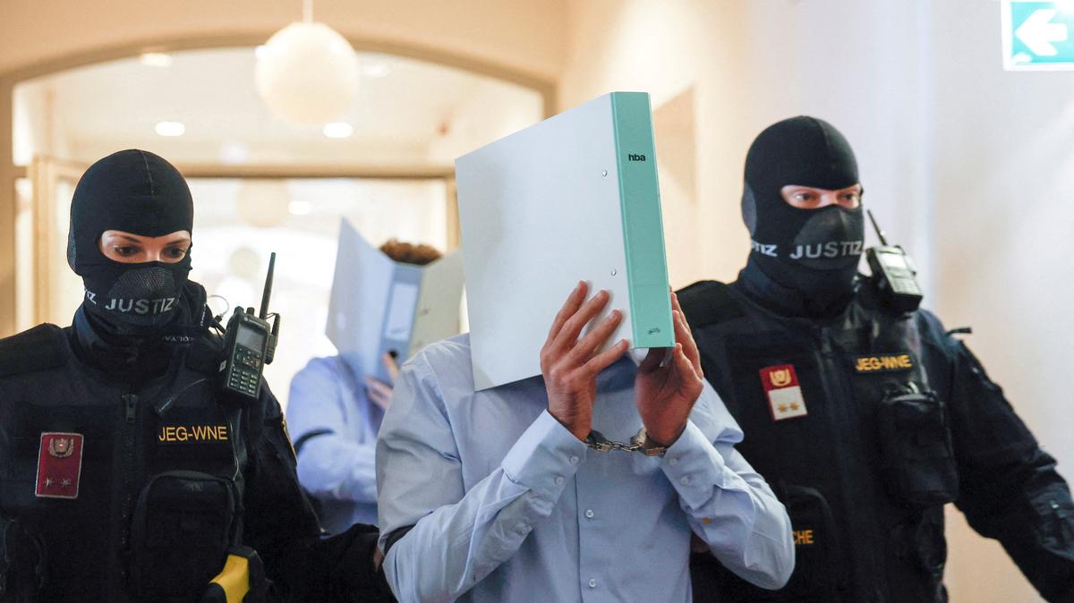 Austrian defendant identified as Beran A, suspected of planning an attack on U.S. singer Taylor Swift's Vienna concert in 2024, is escorted by security personnel in a courtroom for his trial in Wiener Neustadt, Austria, May 28, 2026. REUTERS/Lisa Leutner
