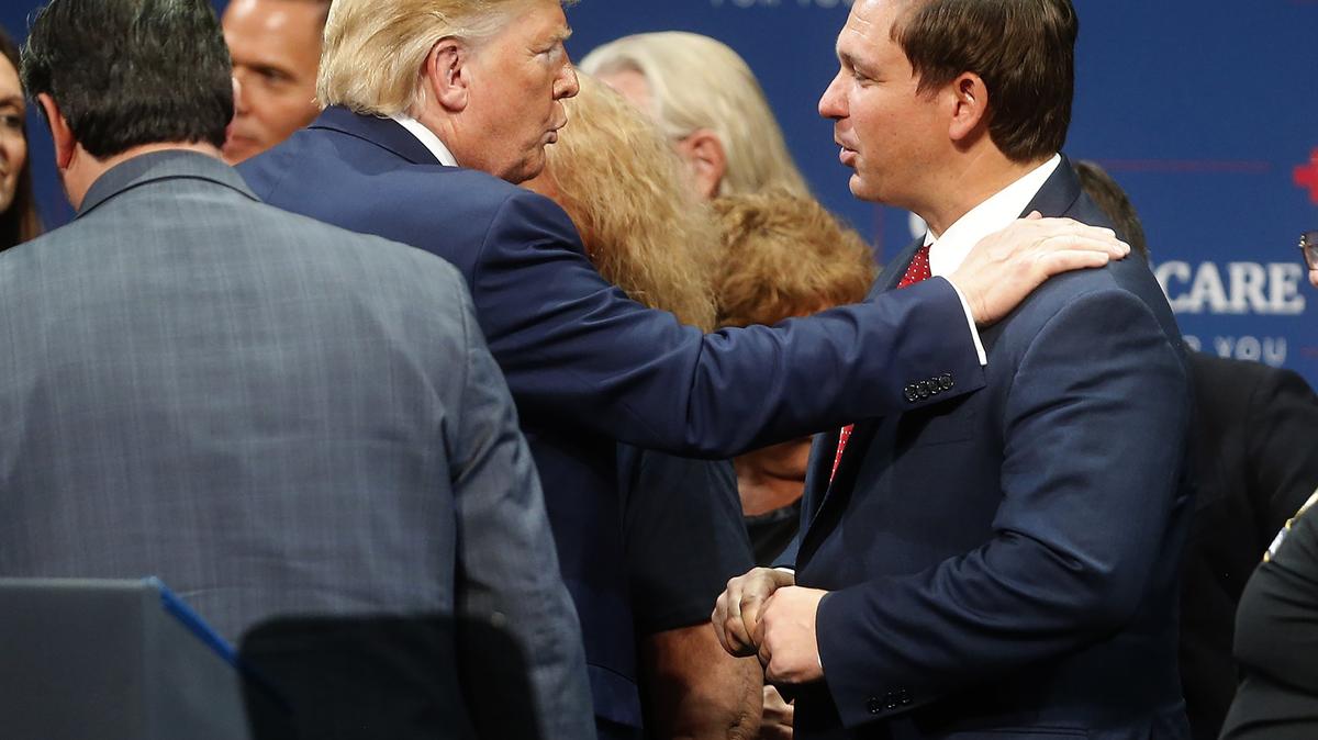 President Donald Trump, left, talks to Florida Gov. Ron DeSantis after giving a speech to his supporters at the Sharon L. Morse Performing Arts Center in The Villages, Florida in 2019. DeSantis' staff on Tuesday said it used partisan criteria in drawing Florida's congressional map. (Octavio Jones/Tampa Bay Times/TNS)