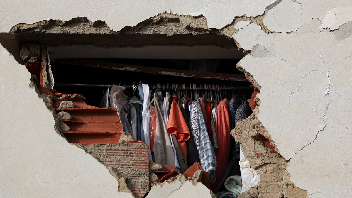 Clothes in a wardrobe peek through a hole in the wall of a damaged building in the aftermath of the June 24 earthquakes, in La Guaira, Venezuela, July 4, 2026. REUTERS/Pablo Sanhueza