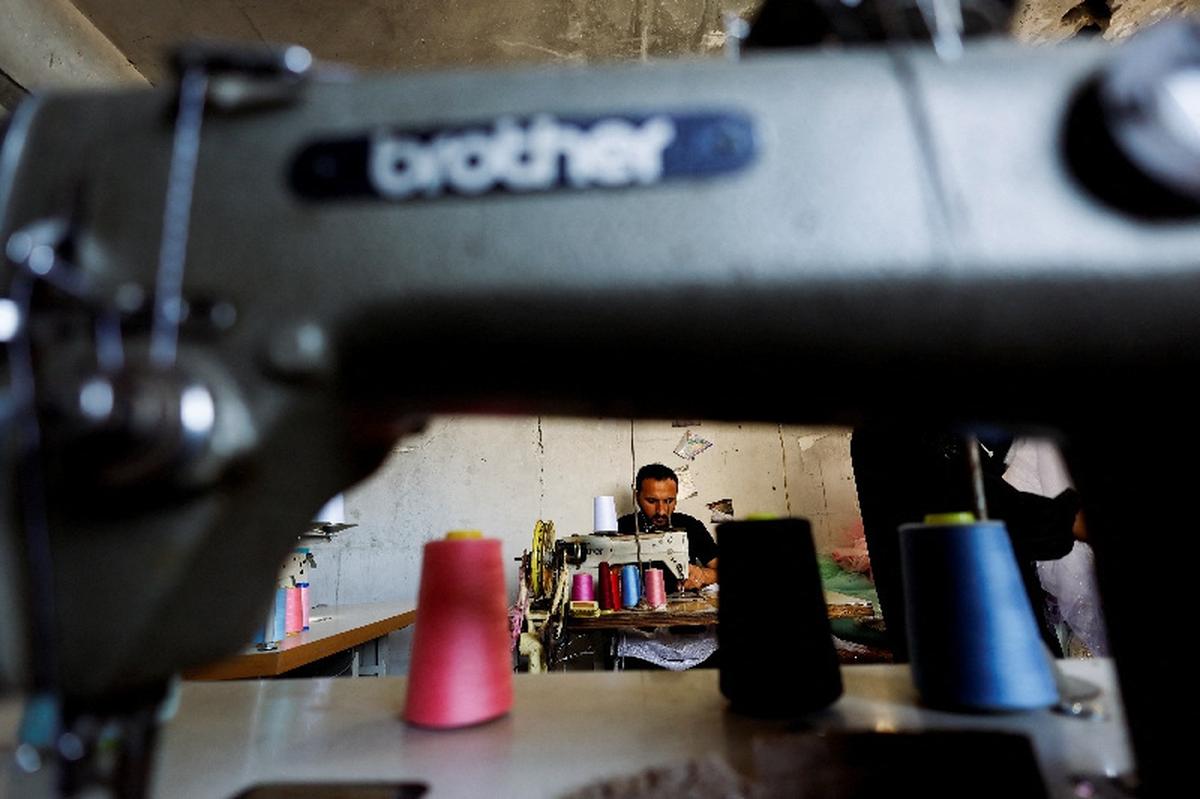 A Palestinian tailor repairs and recycles wedding dresses and children's gowns at a workshop, as families in Gaza turn to reused garments amid soaring prices and shortages caused by the war, in Khan Younis in the southern Gaza Strip, May 10, 2026. REUTERS/Mahmoud Issa