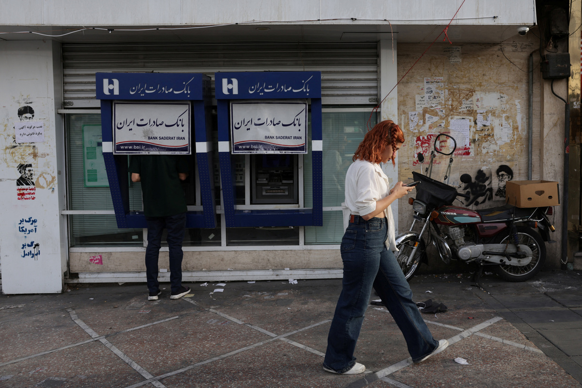 A man uses a Bank Saderat Iran (BSI) ATM at Revolution Square, as preparations are underway ahead of a farewell ceremony for Iran's late Supreme Leader Ayatollah Ali Khamenei, in Tehran, Iran, July 2, 2026. REUTERS/Murad Sezer Foreign media in Iran operate under guidelines set by the Ministry of Culture and Islamic Guidance, which regulates press activity and permissions