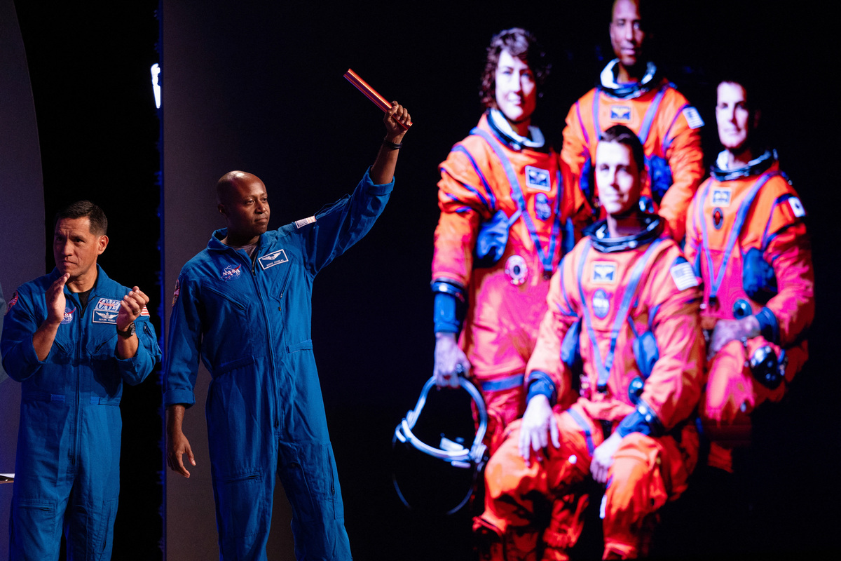 Astronaut Andre Douglas holds up a button as astronaut Frank Rubio claps, during the unveiling for the NASA Artemis III mission, during an event at NASA Johnson Space Center in Houston, Texas, U.S., June 9, 2026. REUTERS/Antranik Tavitian
