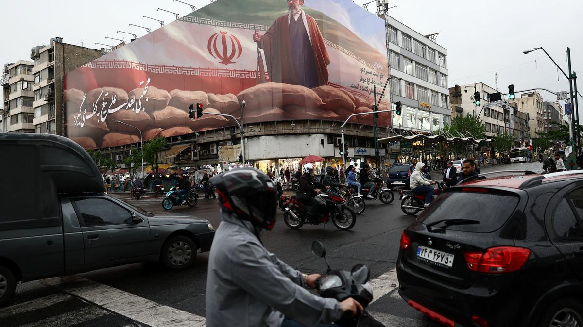 People ride motorcycles near a billboard featuring an image of Iran's new Supreme Leader Mojtaba Khamenei, amid a ceasefire between U.S. and Iran, in Tehran, Iran, April 20, 2026. Majid Asgaripour/WANA (West Asia News Agency) via REUTERS