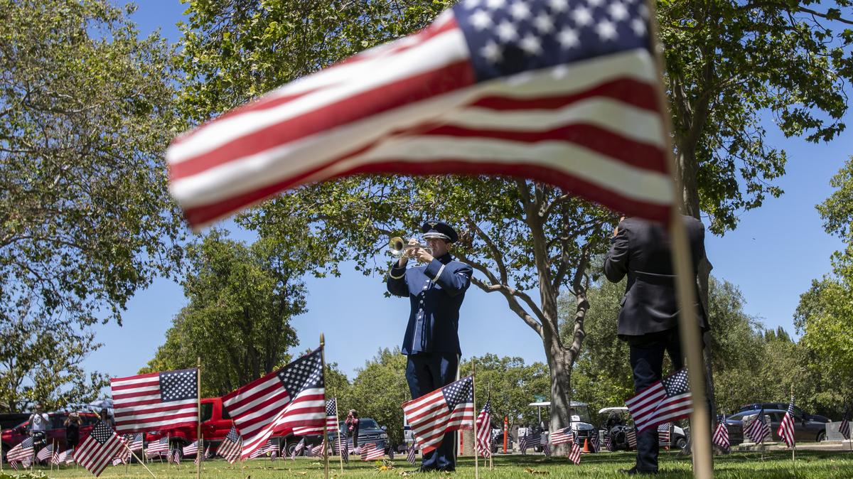 SAN JOSE, CALIFORNIA - MAY 28: A bugler from the USAF Band of the Golden West plays taps near the conclusion of the Memorial Day service at Oak Hill Memorial Park in San Jose, Calif., Monday, May 30, 2022. (Karl Mondon/Bay Area News Group)