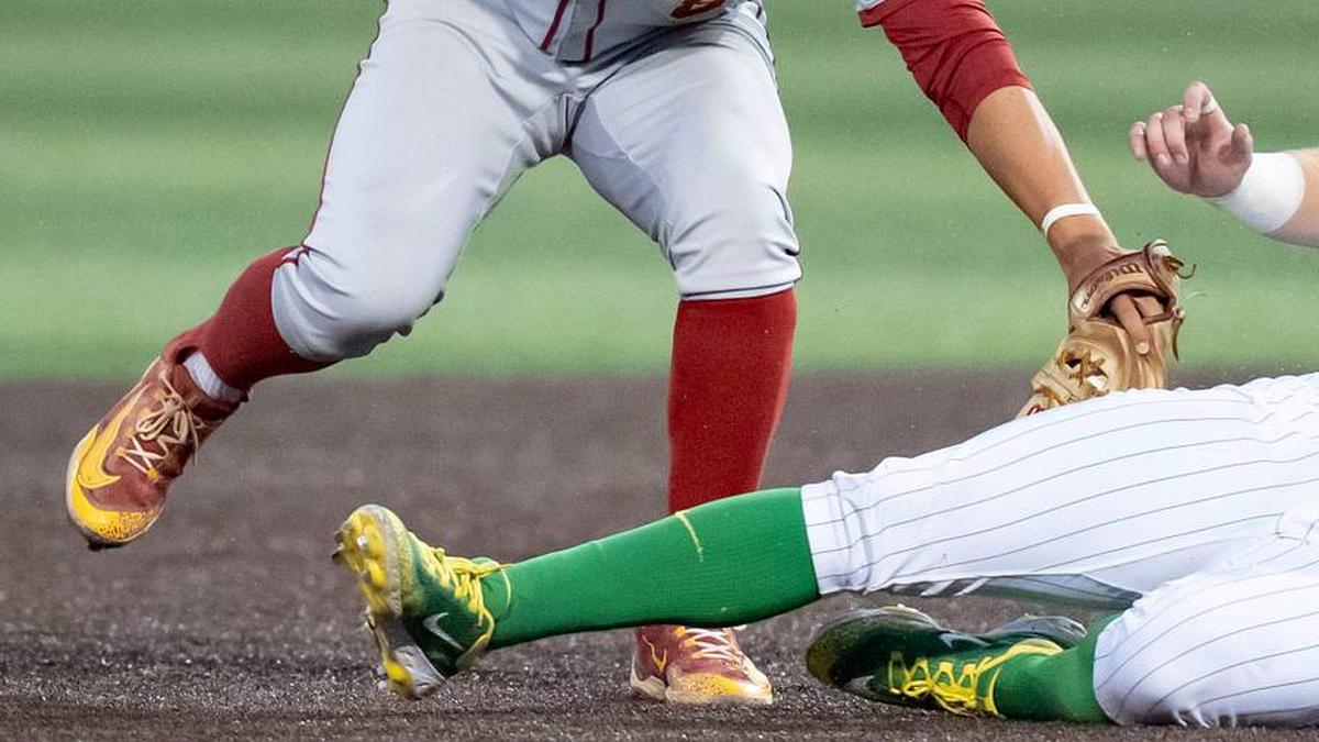  USC's Kevin Takeuchi, left, tags Oregon infielder Ryan Cooney as he slides to second as the Oregon Ducks host the USC Trojans on May 14, 2026, in Eugene, Oregon. | Ben Lonergan/The Register-Guard / USA TODAY NETWORK via Imagn Images 
