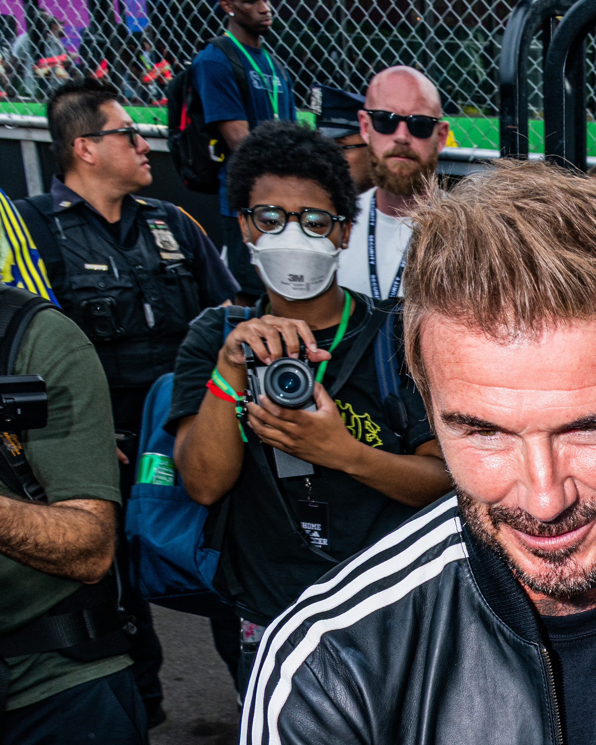 People take photos of former England soccer player David Beckham during an Adidas Home of Soccer event in Brooklyn Bridge Park in New York on June 26, 2026. As World Cup matches take place across the United States, Nike and Adidas, the two largest sportswear companies in the world, are spending millions of dollars in a duel over the future of soccer in America. (Emma Rose Milligan/The New York Times)