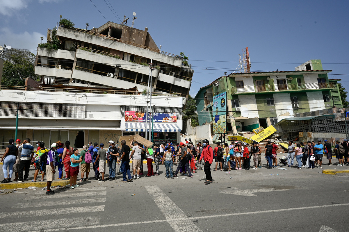 People affected by earthquakes that hit the country line up to receive aid, in La Guaira, Venezuela, June 26, 2026. REUTERS/Maxwell Briceno