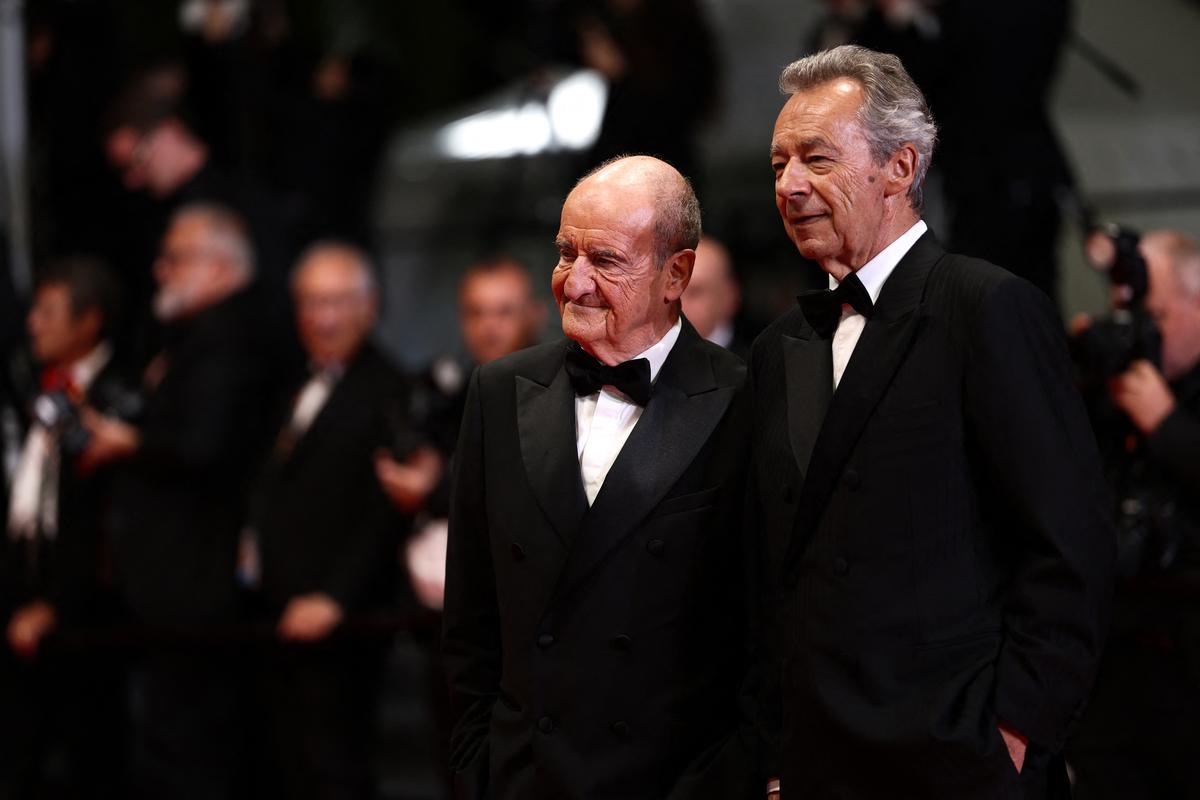 Pierre Lescure and Michel Denisot pose on the red carpet during arrivals for the screening of the film "Coward" in competition at the 79th Cannes Film Festival in Cannes, France, May 21, 2026. REUTERS/Gonzalo Fuentes