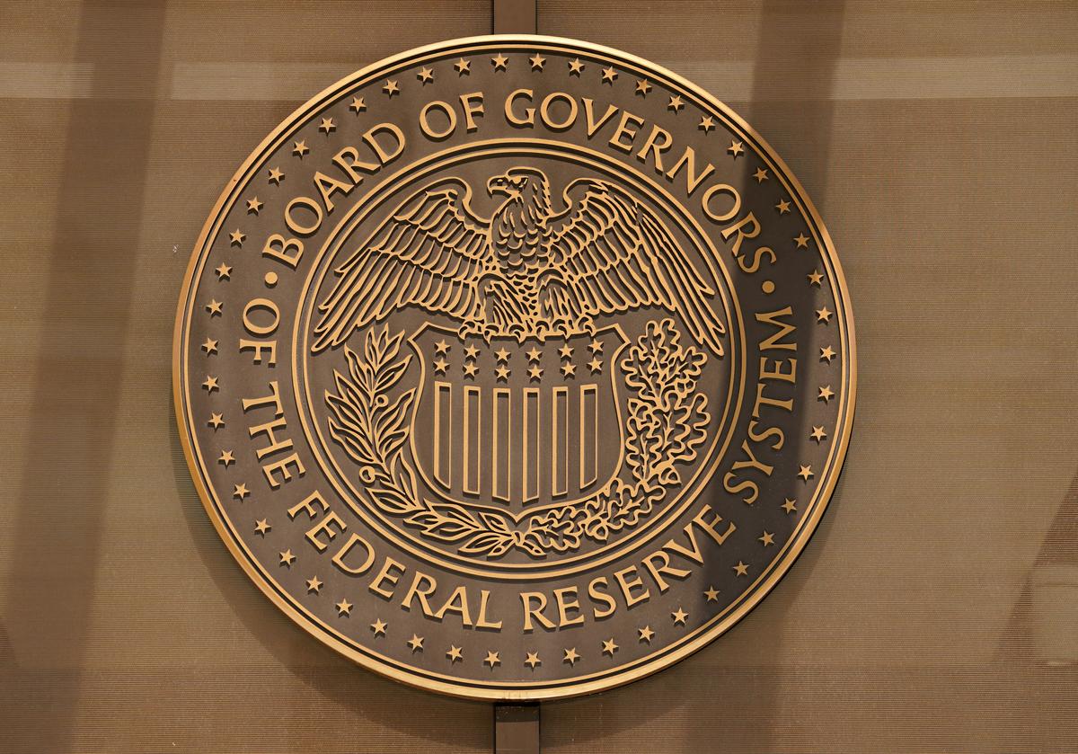 FILE PHOTO: A sign for the Federal Reserve Board of Governors is seen at the entrance to the William McChesney Martin Jr. building in Washington, U.S., September 21, 2022. REUTERS/Kevin Lamarque/File Photo