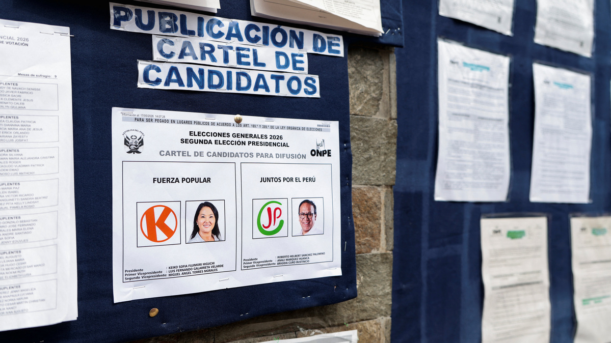 A poster featuring presidential candidates is displayed at a polling station ahead of the June 7 runoff election in Lima, Peru, June 6, 2026. REUTERS/Stifs Paucca