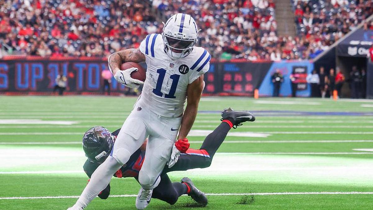  Jan 4, 2026; Houston, Texas, USA; Indianapolis Colts wide receiver Michael Pittman Jr. (11) breaks Houston Texans cornerback Alijah Huzzie (36) tackle and dives for the end zone in the second half half at NRG Stadium. Mandatory Credit: Thomas Shea-Imagn Images | Thomas Shea-Imagn Images 