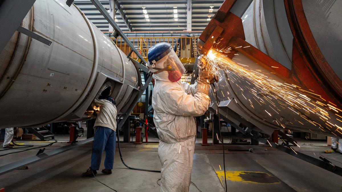 Workers work on a production line, manufacturing tank containers at a factory in Nantong, Jiangsu province, China April 7, 2025. cnsphoto via REUTERS