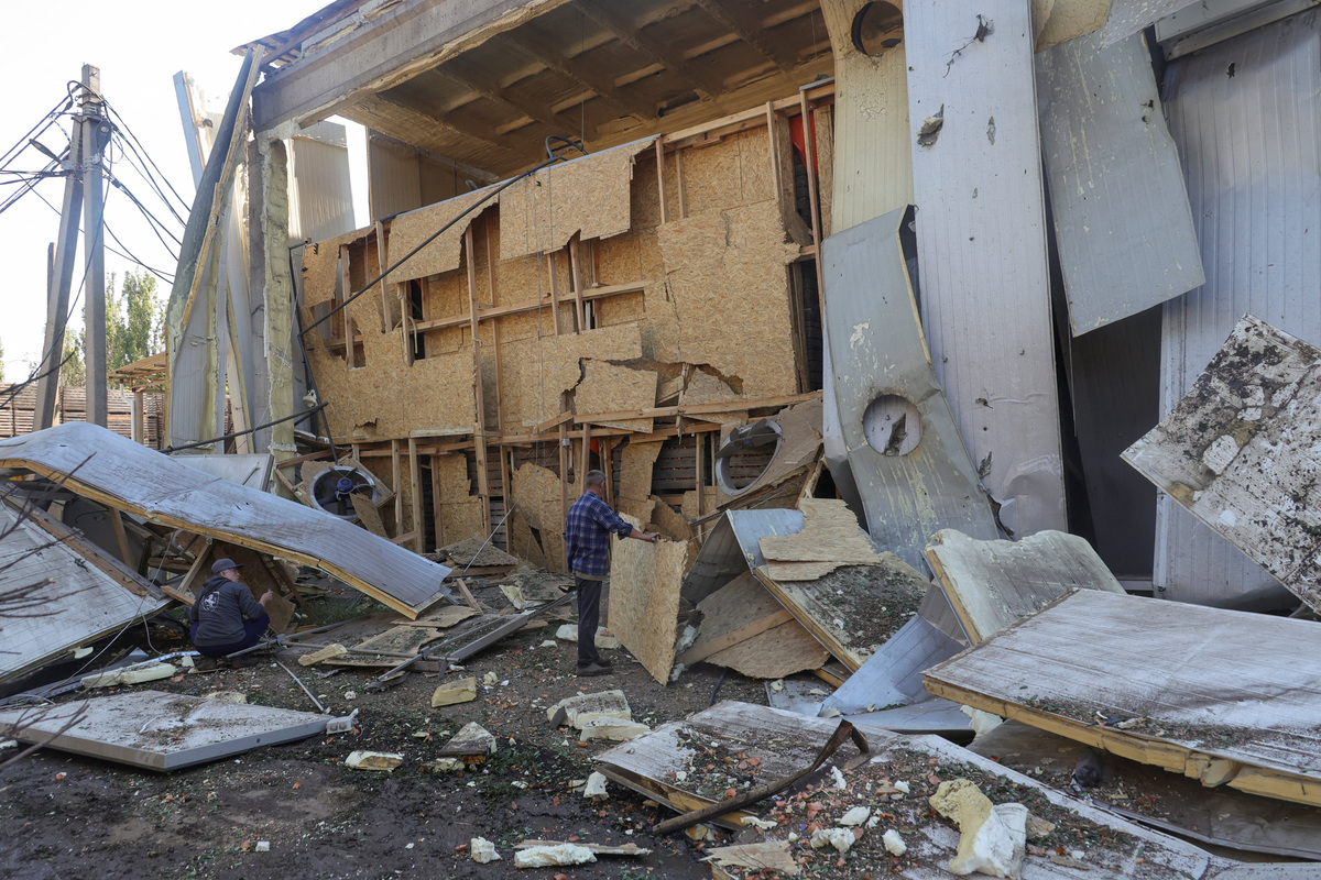 Employees remove debris at a compound of an agricultural enterprise hit by a Russian missile strike on Sunday evening, amid Russia's attack on Ukraine, in Odesa region, Ukraine June 22, 2026. REUTERS/Nina Liashonok