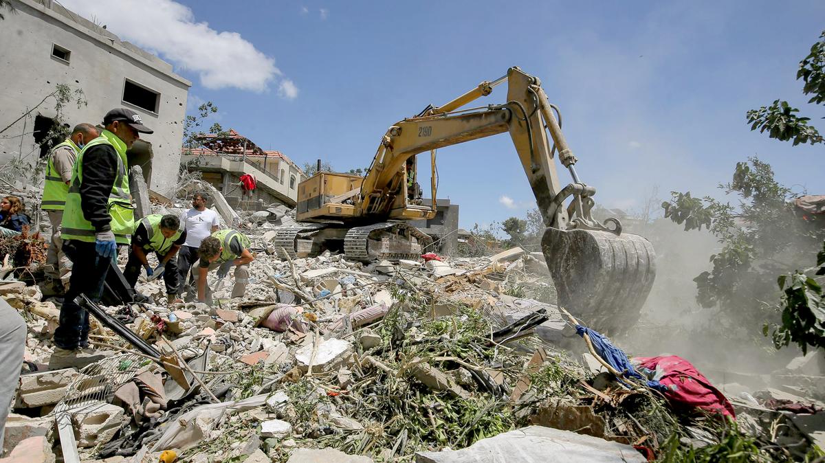 Rescue workers search the rubble of a house destroyed by an Israeli airstrike in the southern Lebanese village of Deir Qanoun al-Naher. (Lebanon says Israeli airstrikes kill 11 amid escalating tensions.) (Marwan Naamani/dpa/TNS)