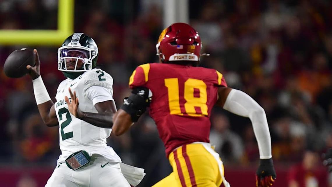  Sep 20, 2025; Los Angeles, California, USA; Michigan State Spartans quarterback Aidan Chiles (2) throws under pressure from Southern California Trojans linebacker Eric Gentry (18) during the first half at the Los Angeles Memorial Coliseum. Mandatory Credit: Gary A. Vasquez-Imagn Images | Gary A. Vasquez-Imagn Images 
