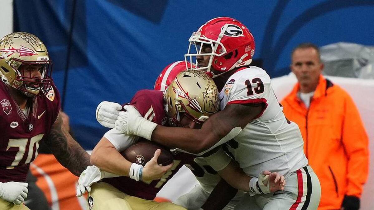  Dec 30, 2023; Miami Gardens, FL, USA; Georgia Bulldogs defensive lineman Mykel Williams (13) makes a tackle on Florida State Seminoles quarterback Brock Glenn (11) during the first half in the 2023 Orange Bowl at Hard Rock Stadium. Mandatory Credit: Jasen Vinlove-Imagn Images | Jasen Vinlove-Imagn Images 