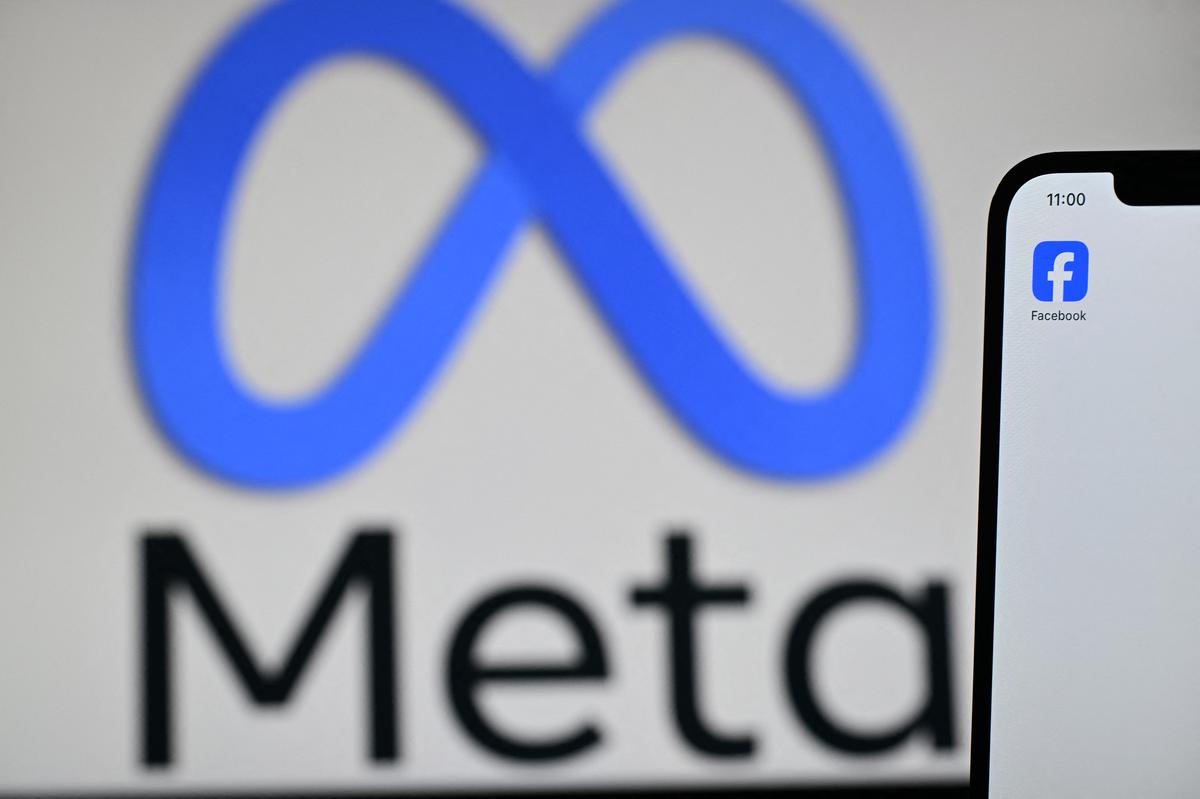  An illustration photograph taken on February 20, 2025, shows Meta’s logo displayed on a laptop screen next to the Facebook app on a phone screen, in a residential property in Guildford, south of London. (Photo by Justin Tallis/AFP via Getty Images) 