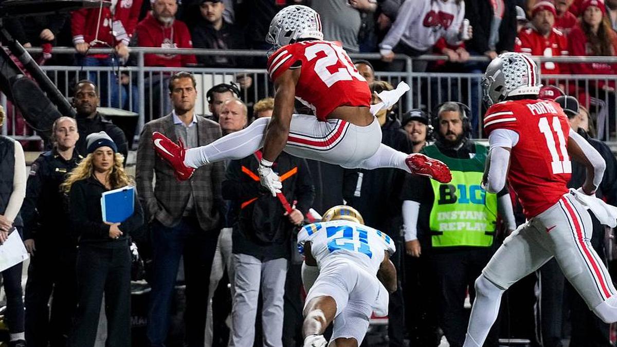  Ohio State Buckeyes running back James Peoples (20) hurdles over UCLA Bruins defensive back Cole Martin (21) in the first half of the NCAA college football game at Ohio Stadium on Saturday, Nov. 15, 2025 in Columbus, Ohio. | Samantha Madar/Columbus Dispatch / USA TODAY NETWORK via Imagn Images 