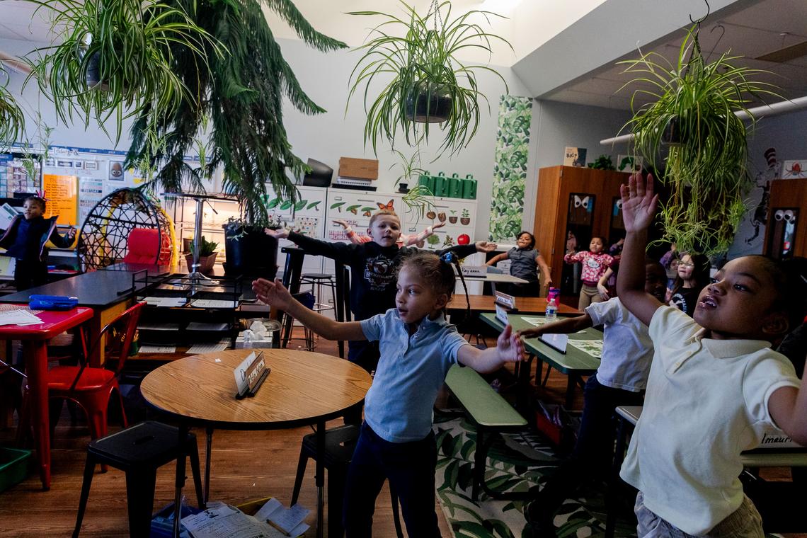  First grade students do jumping jacks during a "brain break" in a classroom at McKinley STEAM Academy on March 12, 2026, in Toledo, Ohio. Credit: Sylvia Jarrus for The Hechinger Report