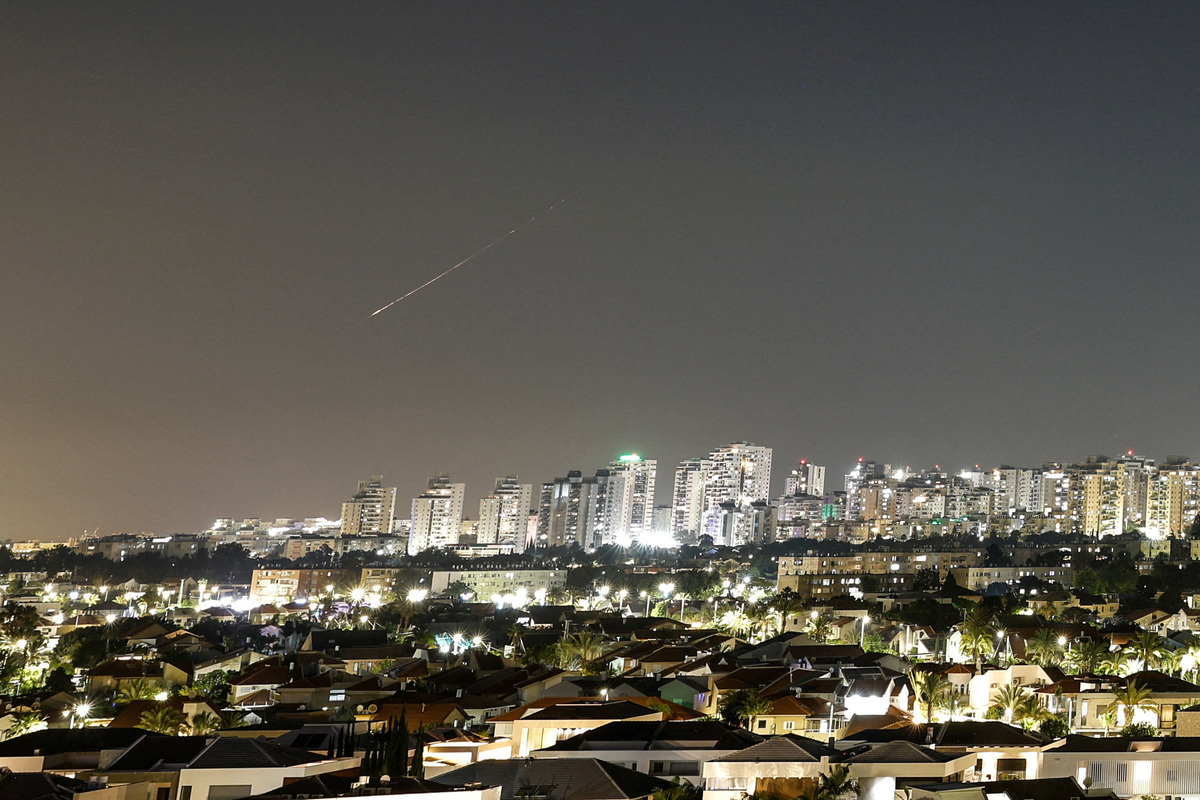 A streak of light illuminates the sky during a missile attack from Iran towards Israel as seen from Ashkelon, Israel, June 7, 2026. REUTERS/Amir Cohen