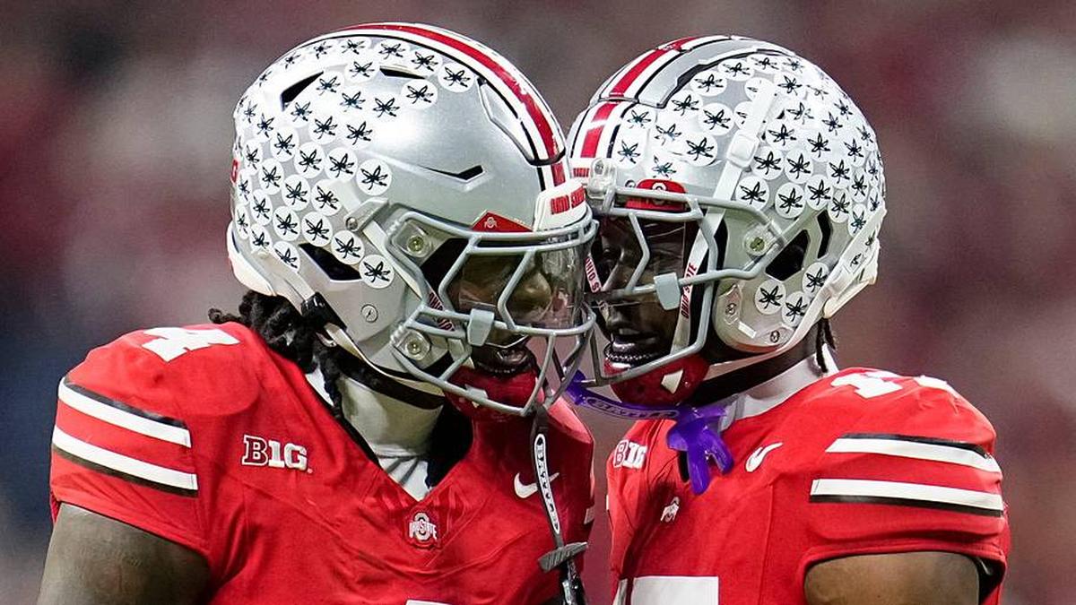  Ohio State Buckeyes wide receiver Jeremiah Smith (4) celebrates with wide receiver Carnell Tate (17) during the first half of the Big Ten Conference championship game against the Indiana Hoosiers at Lucas Oil Stadium in Indianapolis on Dec. 6, 2025. | Adam Cairns/Columbus Dispatch / USA TODAY NETWORK via Imagn Images 