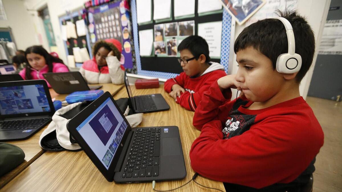 Fifth-grade students work on a laptop computers in a classroom of students at 99th Street Elementary school in South Los Angeles on the fourth day of the Los Angeles teachers strike Jan. 17, 2019. (Al Seib/Los Angeles Times/TNS)