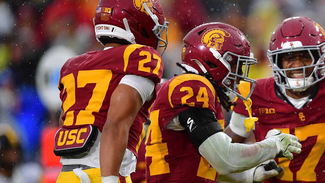  Nov 15, 2025; Los Angeles, California, USA; Southern California Trojans cornerback Alex Graham (27) safety Christian Pierce (24) cornerback Decarlos Nicholson (17) and safety Kennedy Urlacher (28) celebrate after Iowa Hawkeyes turn the ball over on fourth down during the second half at the Los Angeles Memorial Coliseum. Mandatory Credit: Gary A. Vasquez-Imagn Images | Gary A. Vasquez-Imagn Images 