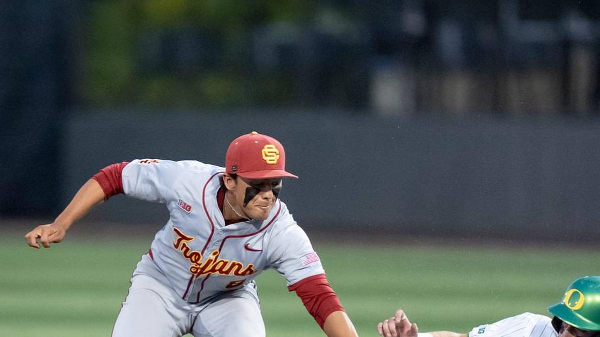  USC's Kevin Takeuchi, left, tags Oregon infielder Ryan Cooney as he slides to second as the Oregon Ducks host the USC Trojans on May 14, 2026, in Eugene, Oregon. | Ben Lonergan/The Register-Guard 