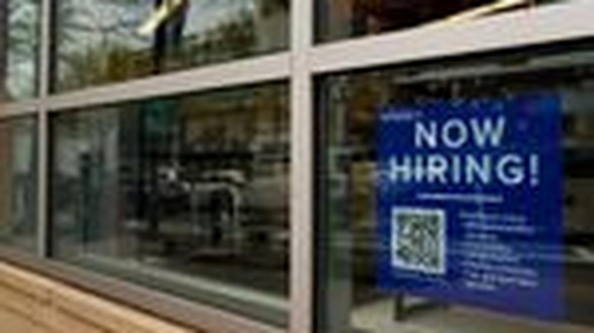 An employee hiring sign with a QR code is seen in a window of a business in Arlington, Virginia, U.S., April 7, 2023. REUTERS/Elizabeth Frantz/File Photo