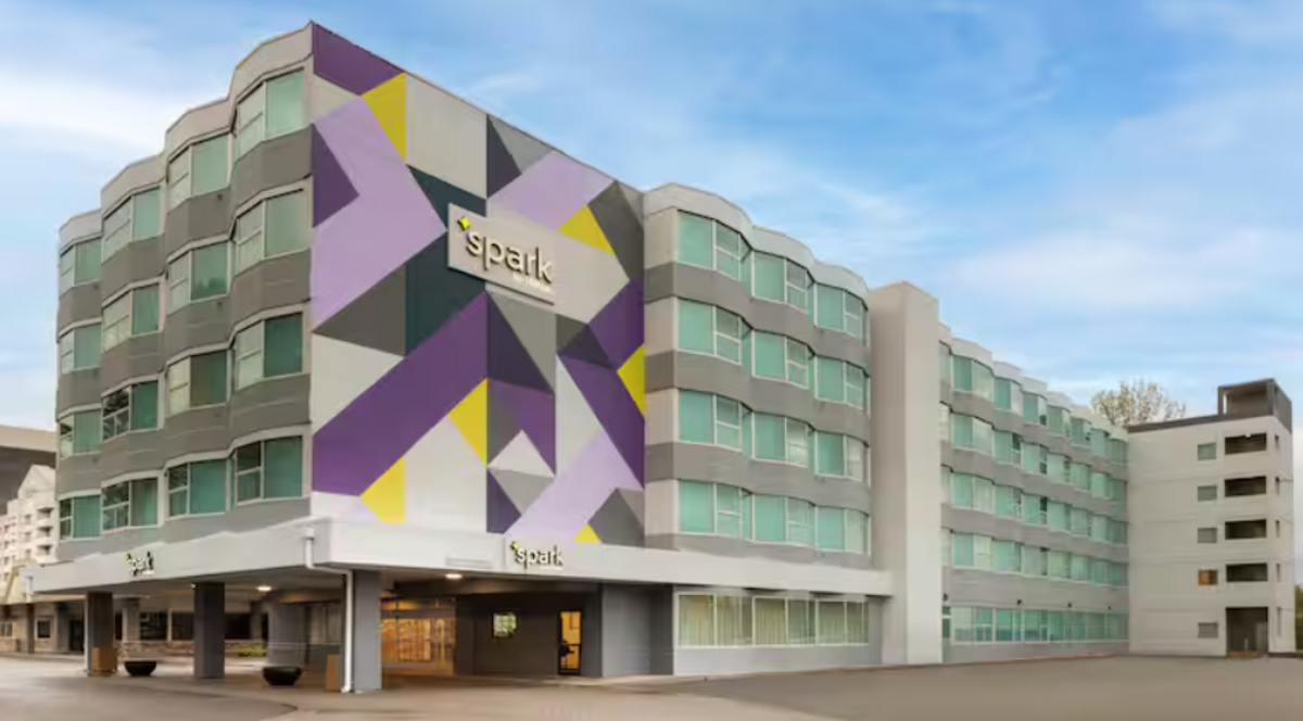  The purple and white facade of the Spark by  Hilton  Seattle Airport. Photo courtesy of Spark by  Hilton 