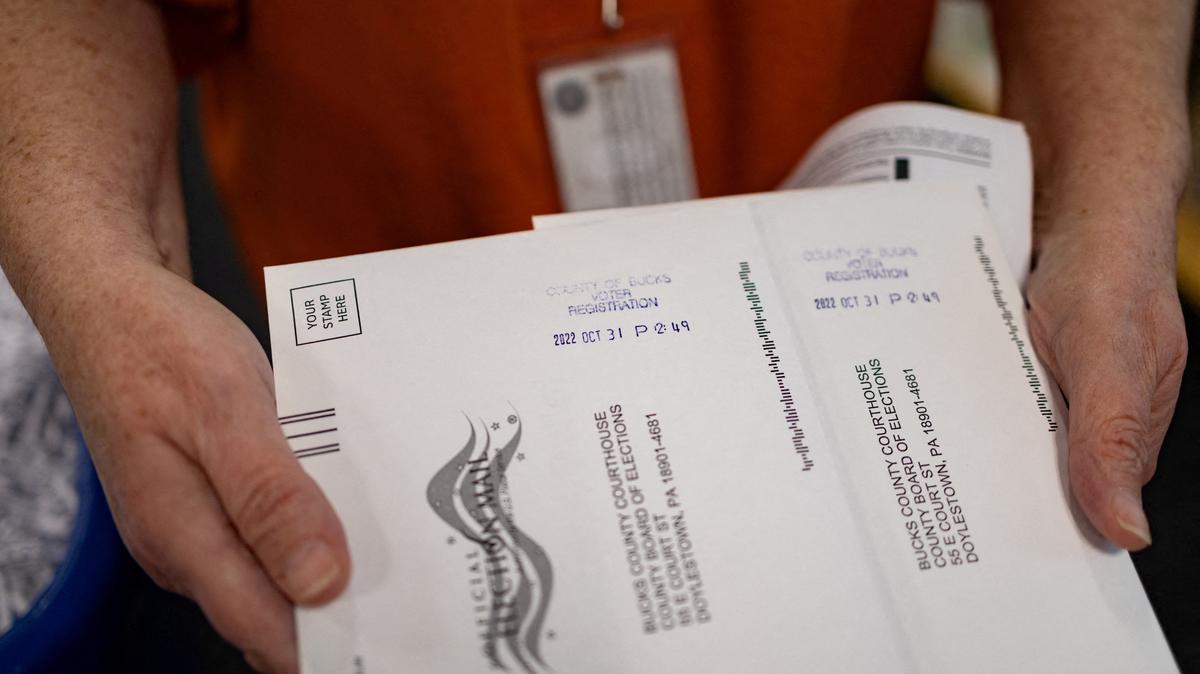 FILE PHOTO: "On Demand" absentee or mail-in ballots are time stamped after being filled out in Doylestown, Pennsylvania, U.S. October 31, 2022. REUTERS/Hannah Beier
