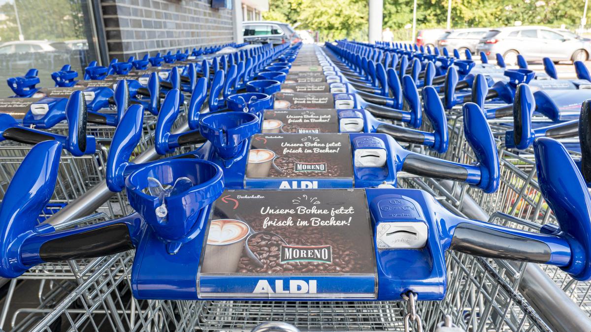 Aldi Shopping Cart. Neuruppin, Brandenburg/Germany - 25.07.2019: A row of modern shopping trolleys of the supermarket Aldi interlocked with drink holder, self-promotion and the coin slot in Neuruppin.