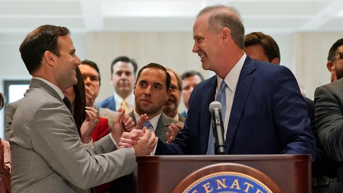 Speaker of the House Chris Sprowls, left, and Senate President Wilton Simpson shake hands as they celebrate the end of a legislative session, Friday, April 30, 2021, at the Capitol in Tallahassee, Fla.