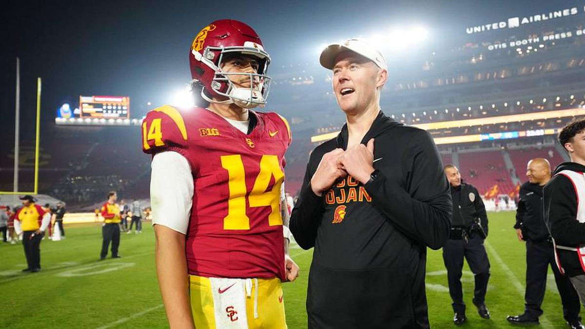  Nov 29, 2025; Los Angeles, California, USA; Southern California Trojans quarterback Jayden Maiava (14) and head coach Lincoln Riley react after the game against the UCLA Bruins at United Airlines Field at Los Angeles Memorial Coliseum. Mandatory Credit: Kirby Lee-Imagn Images | Kirby Lee-Imagn Images 