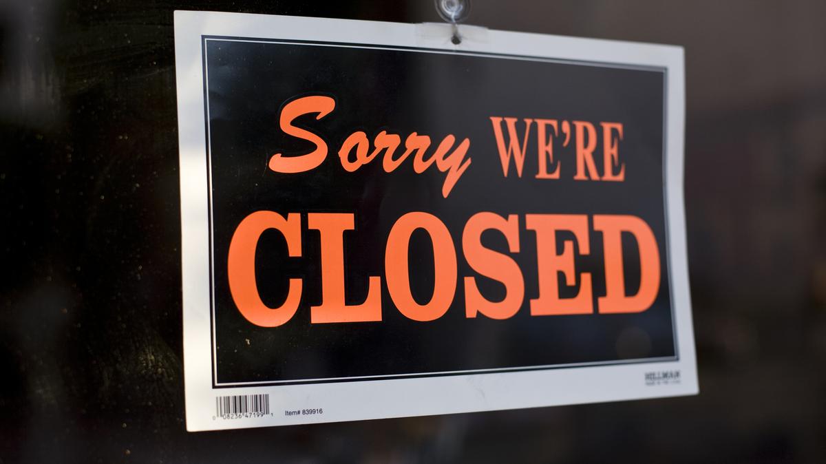 USA – Closed Sign. A sign behind a store window reads "Sorry We're Closed". (Photo by James Leynse/Corbis via Getty Images)