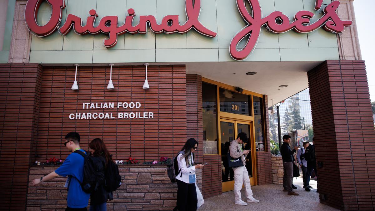 Attendees of the Nvidia GTC 2026 conference stand in front of Original Joe’s in San Jose, Calif., on Thursday, March 19, 2026. (Dai Sugano/Bay Area News Group)