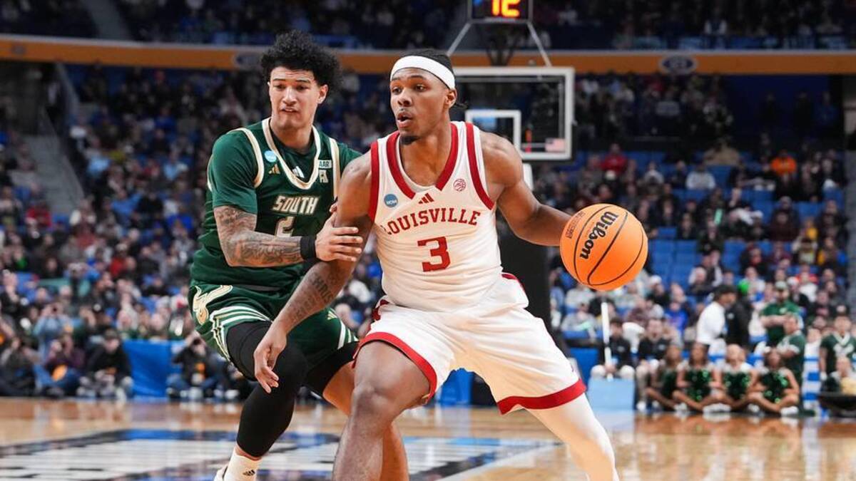  Mar 19, 2026; Buffalo, NY, USA; Louisville Cardinals guard Ryan Conwell (3) drives to the basket against South Florida Bulls guard Wes Enis (2) during the second half during a first round game of the men's 2026 NCAA Tournament at Keybank Center. Mandatory Credit: Gregory Fisher-Imagn Images | Gregory Fisher-Imagn Images 