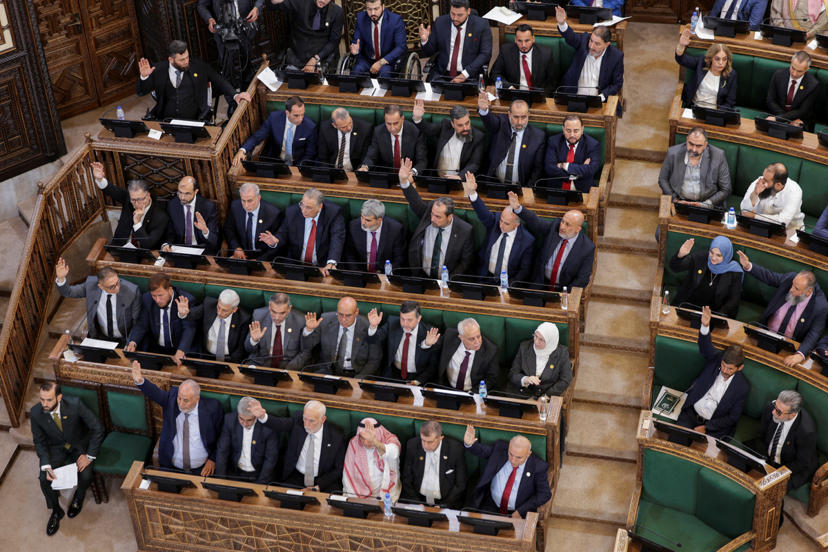 Members of Syria's newly formed People's Assembly take part in a vote during the body's inaugural session, the first parliament session since the end of the rule of ousted Syrian President Bashar al-Assad, in Damascus, Syria, July 12, 2026. REUTERS/Khalil Ashawi