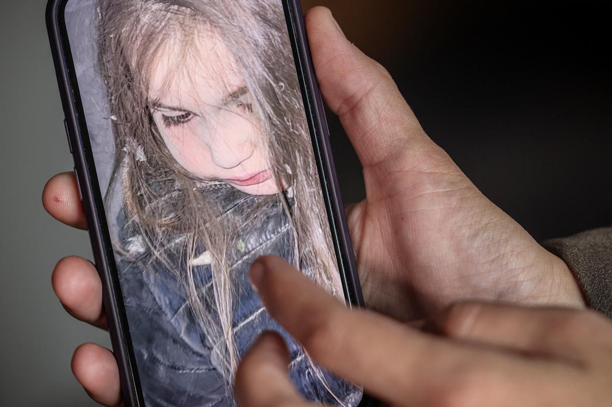 Olha Mudra, 35, a resident who survived yesterday's Russian missile and drone attack, shows a photo of her 6-year-old daughter Nataliia covered in ash, taken soon after the strike happened, amid Russia's attack on Ukraine, in Kyiv, Ukraine, July 3, 2026. REUTERS/Alina Smutko