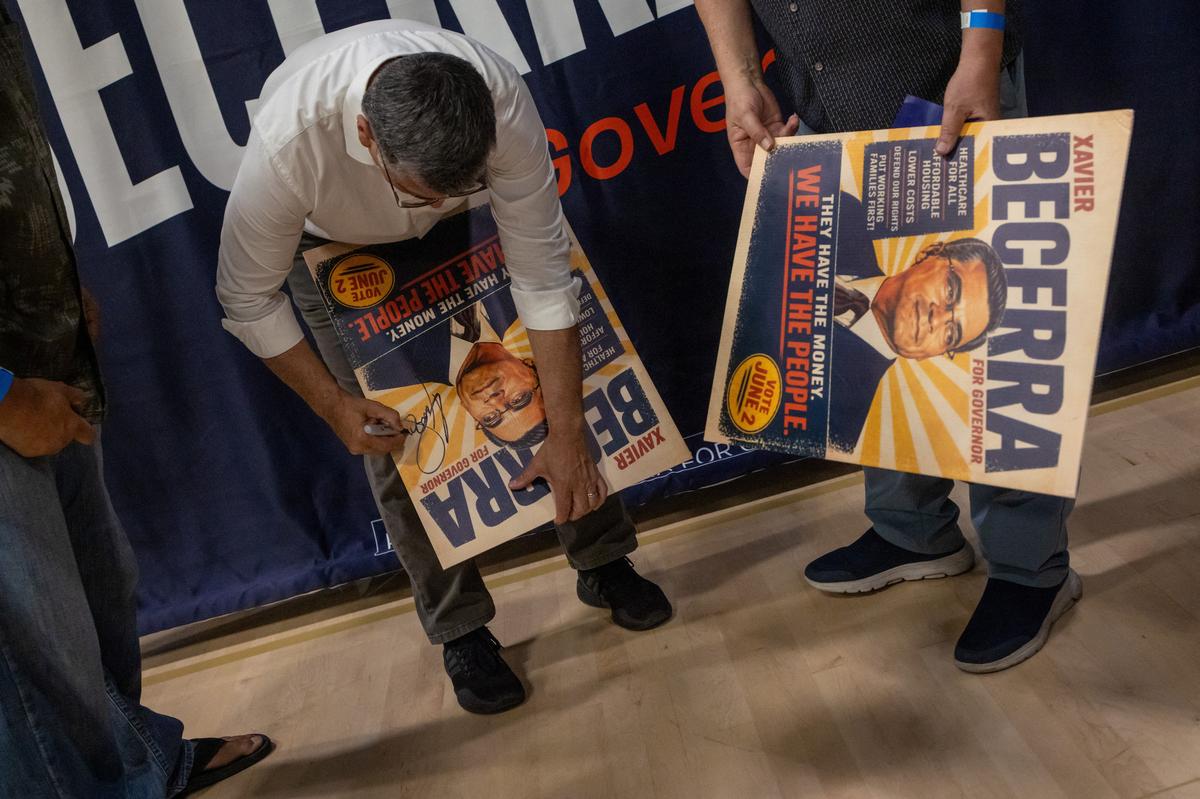 California gubernatorial candidate Xavier Becerra signs a banner during a campaign event at the Yosemite Hall of Sacramento State University in Sacramento, California, U.S., May 11, 2026. REUTERS/Carlos Barria